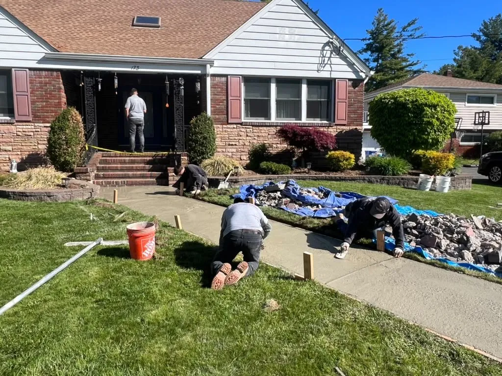 Pro One crew installing a new front walkway at a brick ranch home